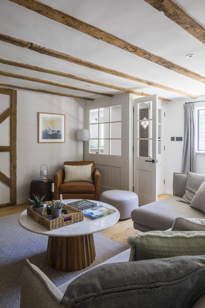 Heritage residential conversion in Sussex featuring living room with couch and coffee table - Stickland Wright Architecture and Interior Design