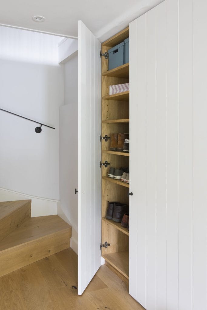 Interior of Sussex residential conversion featuring hidden shoe storage. Stickland Wright Architecture and Interior Design